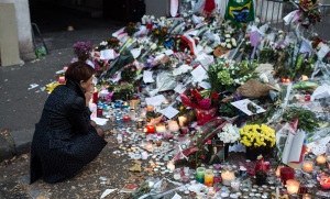 PARIS, FRANCE - NOVEMBER 16: A woman mourns the victims near the Bataclan concert hall on November 16, 2015 in Paris, France. A Europe-wide one-minute silence was held at 12pm CET today in honour of at least 129 people who were killed last Friday in a series of terror attacks in the French capital. (Photo by David Ramos/Getty Images)